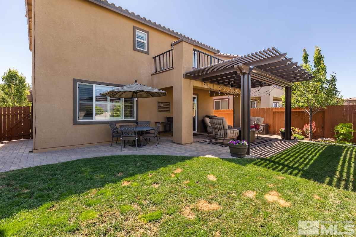 10701 Cordero Drive Reno, NV 89521 - Photo 24 of 25 a view of a house with a backyard and a patio