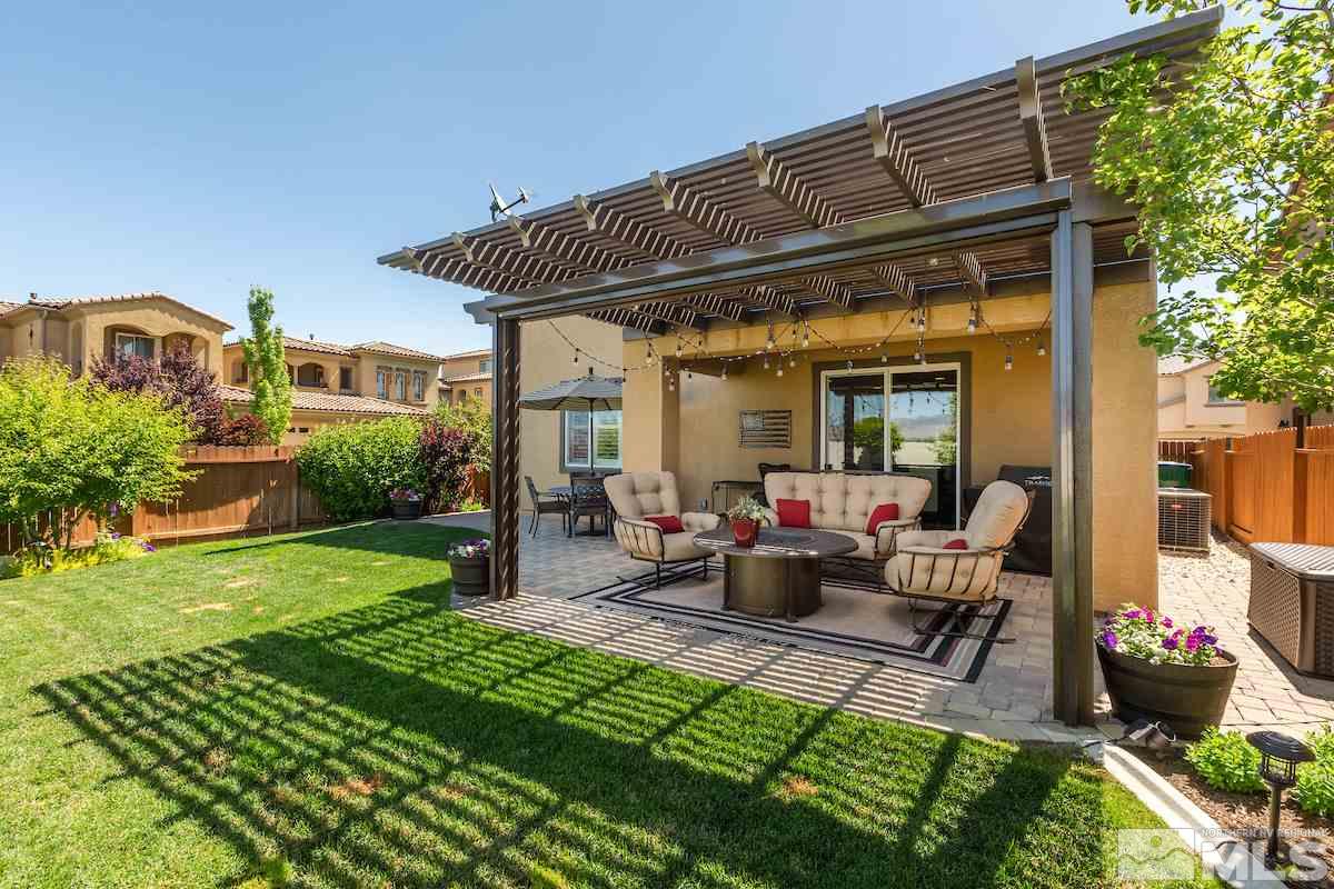 10701 Cordero Drive Reno, NV 89521 - Photo 25 of 25 a view of a patio with table and chairs potted plants and a large tree
