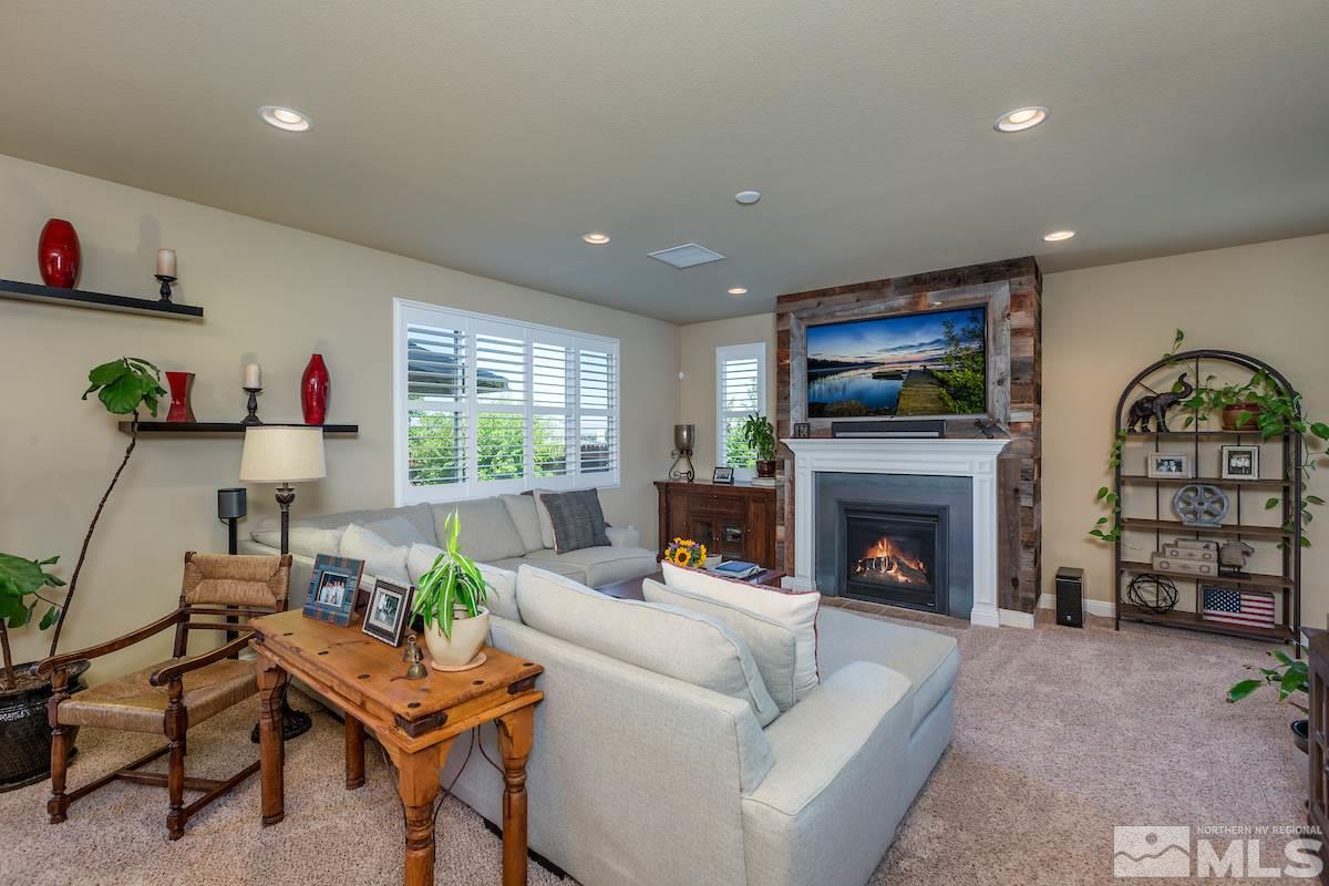 10701 Cordero Drive Reno, NV 89521 - Photo 4 of 25 a living room with furniture a fireplace and a flat screen tv