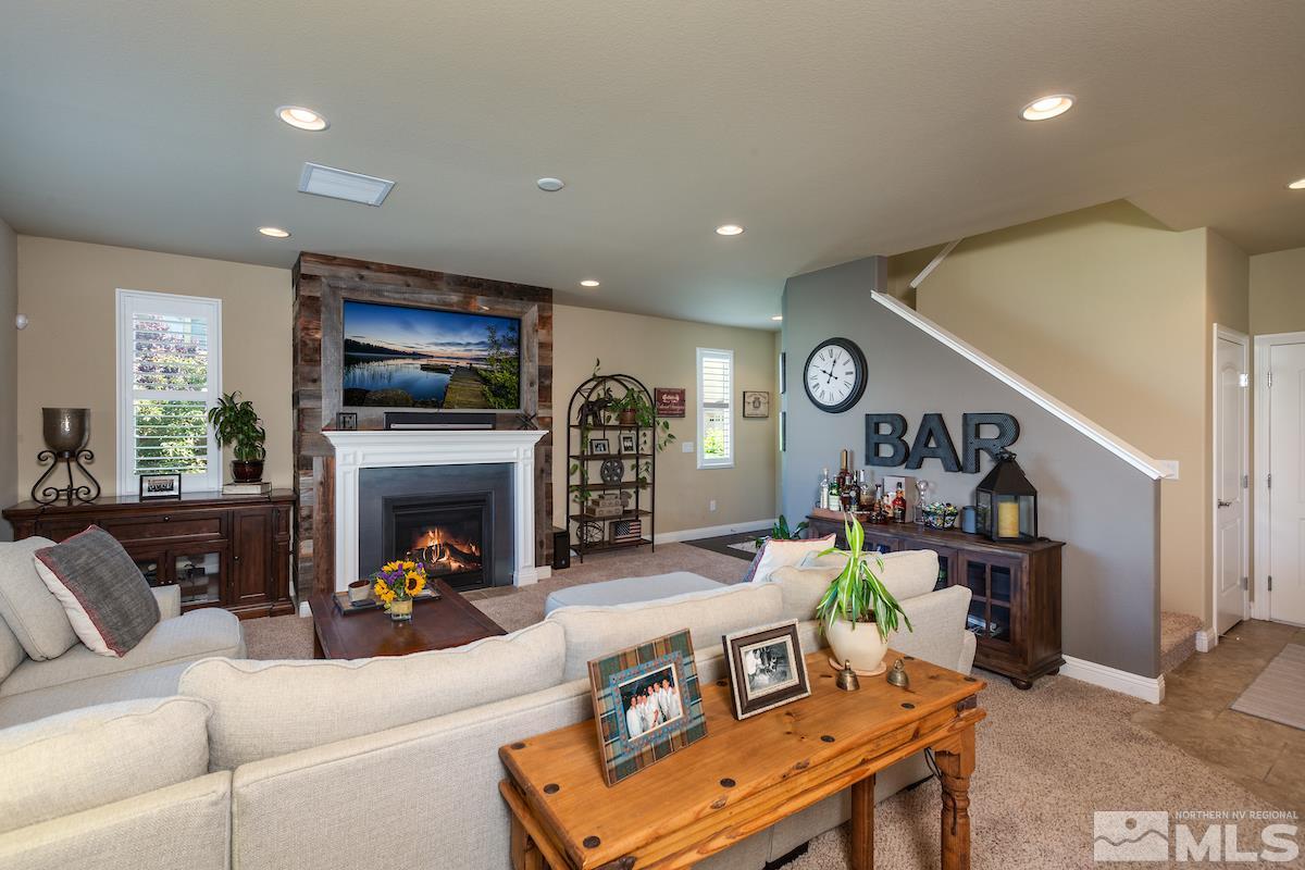 10701 Cordero Drive Reno, NV 89521 - Photo 5 of 25 a living room with furniture a fireplace and a flat screen tv