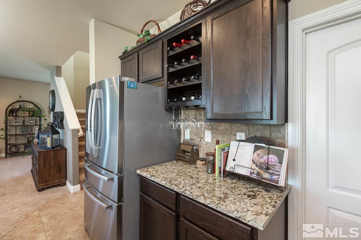10701 Cordero Drive Reno, NV 89521 - Photo 10 of 25 a kitchen with stainless steel appliances granite countertop a refrigerator and a stove