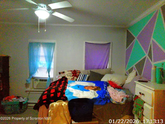 a bedroom with a bed and a chandelier