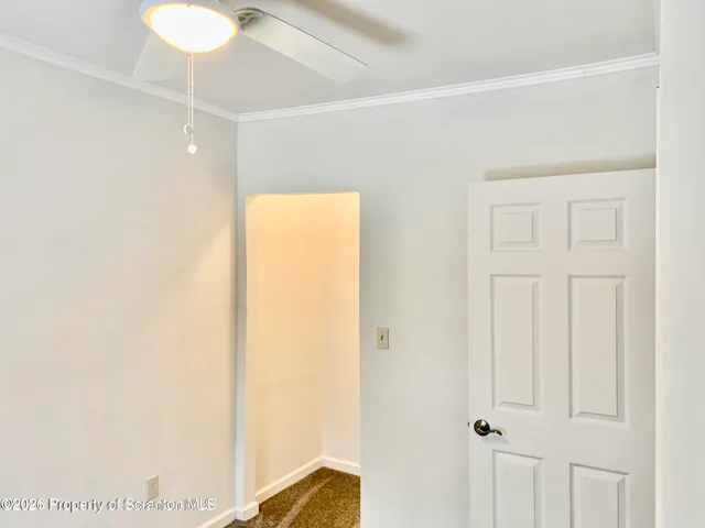 a view of a room with wooden floor and closet