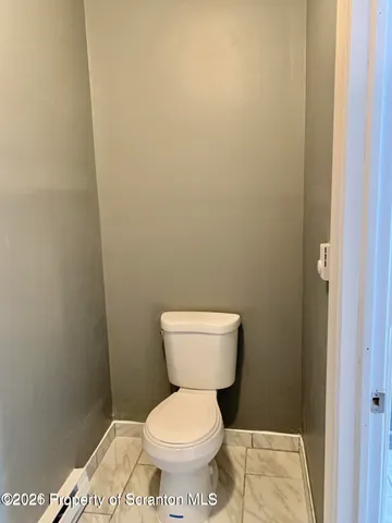 a white toilet sitting in a bathroom