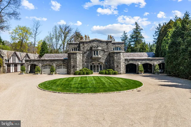 a front view of a house with a yard and outdoor seating