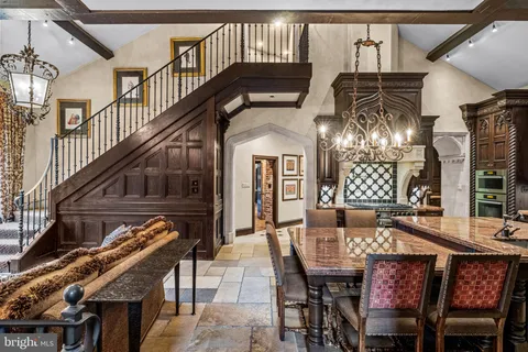 a kitchen with a stove and a dining table