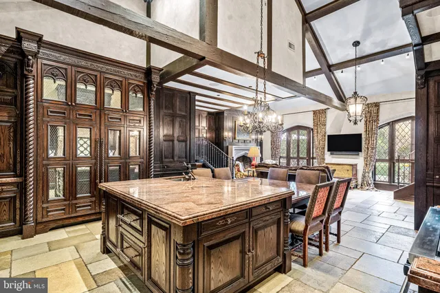 a living room with furniture a fireplace and a chandelier