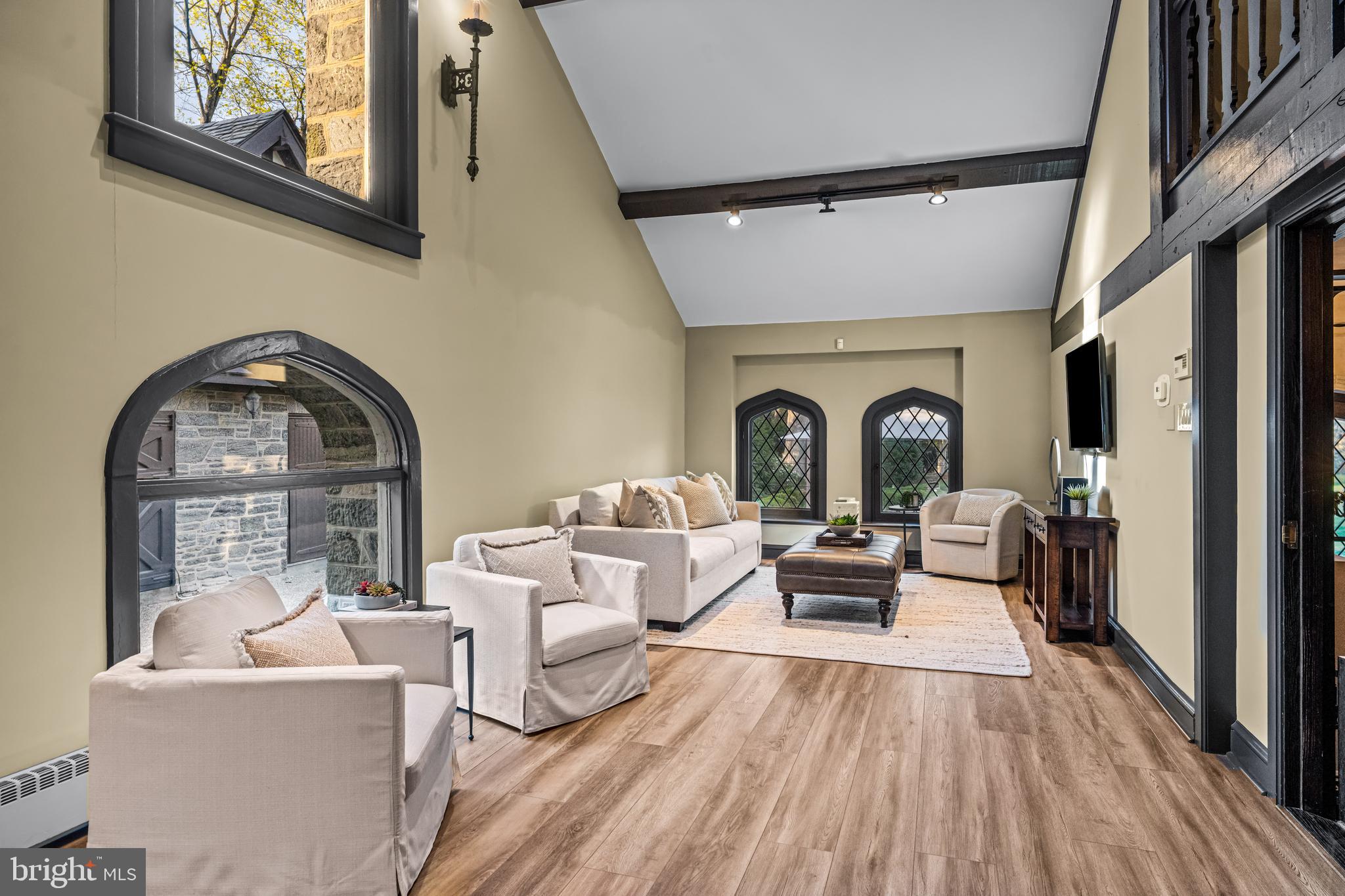 56 Crosby Brown Road Gladwyne, PA 19035 - Photo 26 of 51 a living room with furniture a fireplace and a floor to ceiling window