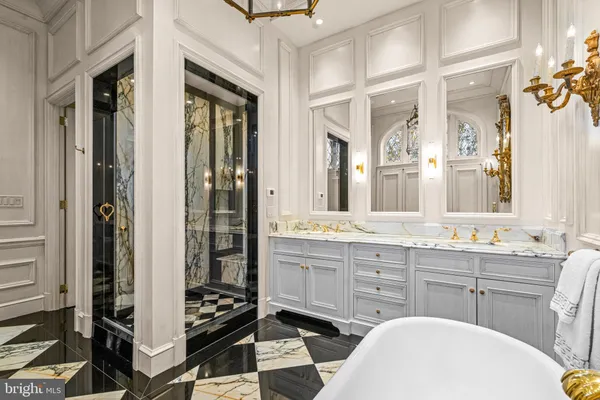 a bathroom with a double vanity sink a mirror and a shower