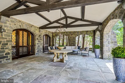 a view of two chairs and table in a patio