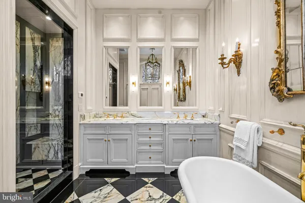 a dining room with stainless steel appliances a sink and a chandelier