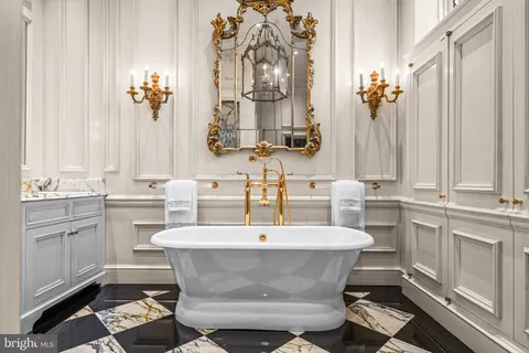 a bedroom with a bed a dresser and potted plants