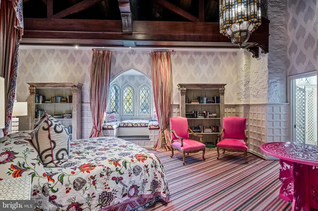 a bedroom with a bed chair and a window