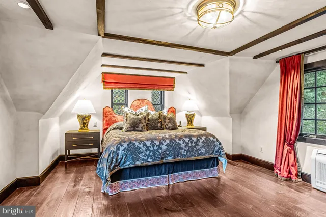 a front view of a house with sitting area and garden