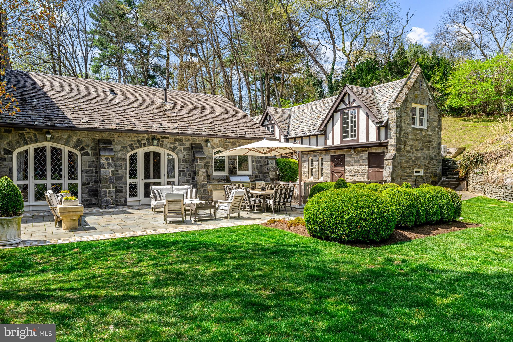 56 Crosby Brown Road Gladwyne, PA 19035 - Photo 46 of 51 a front view of a house with sitting area and garden