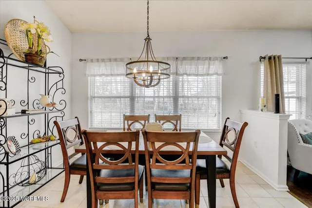 a view of a dining room with furniture wooden floor and chandelier