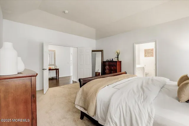 a bedroom with a large bed and a couch