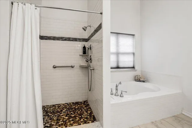 a bathroom with a bathtub and a shower