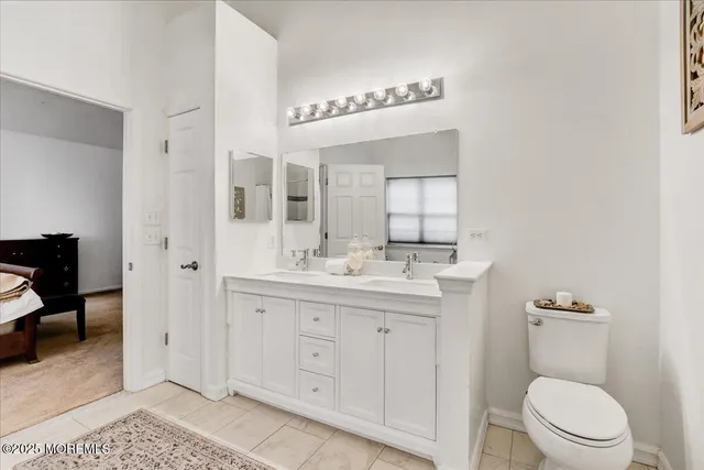 a bathroom with a toilet a sink and mirror