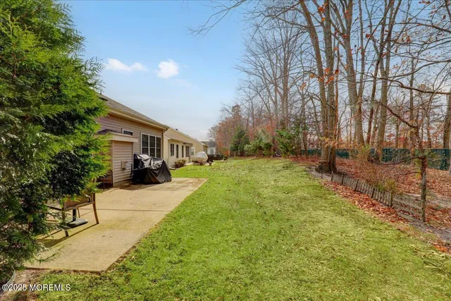 a front view of a house with a yard and trees