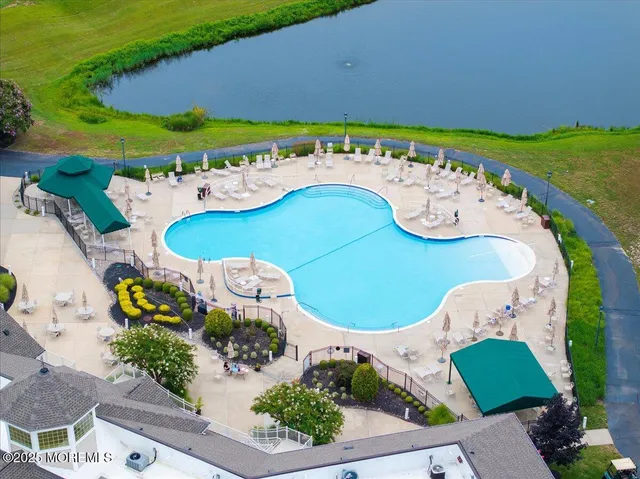 an aerial view of a house with a swimming pool patio and outdoor seating