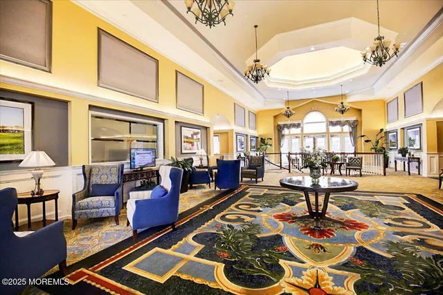 a living room with furniture floor to ceiling window and pool table