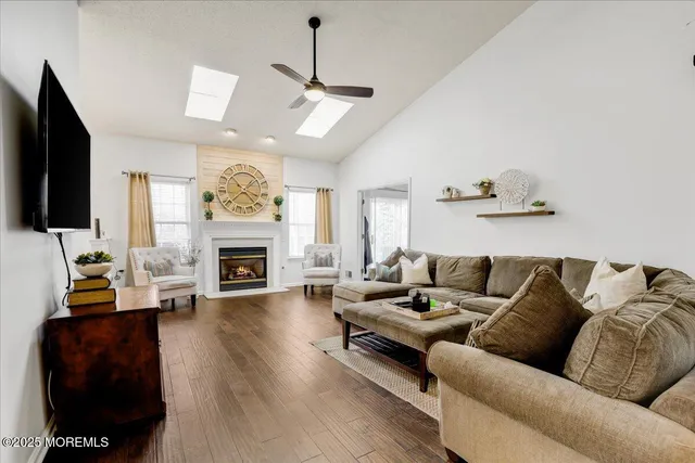 a living room with furniture a fireplace and a flat screen tv