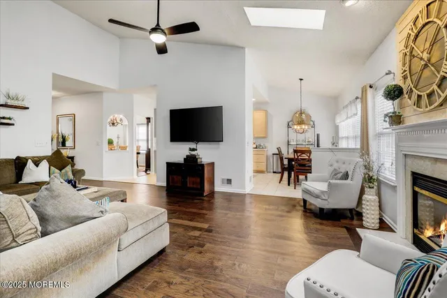 a living room with furniture a fireplace and a flat screen tv