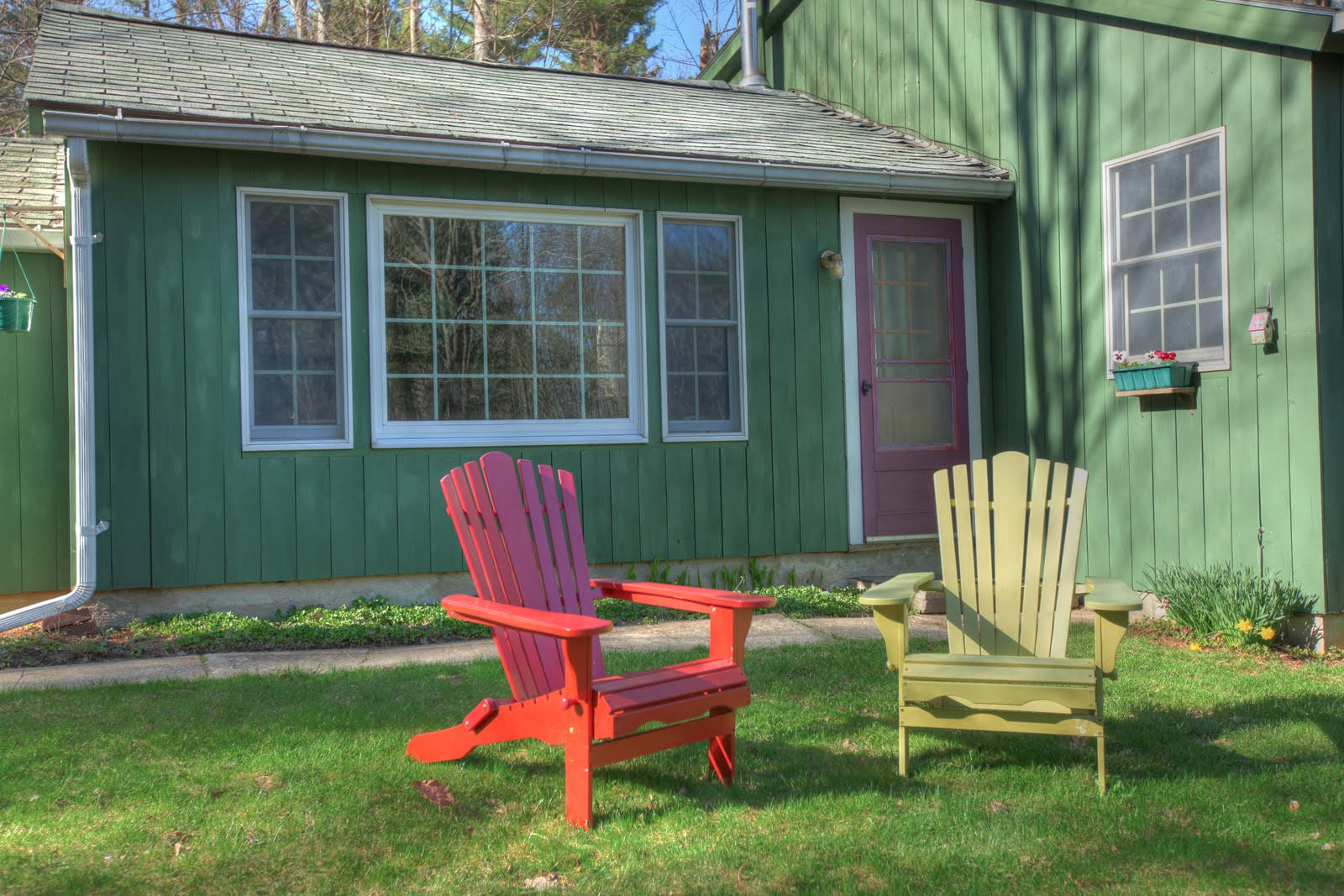 36 Blue Hill Road Monterey, MA 01245 - Photo 6 of 34 a front view of a house with a garden and chairs