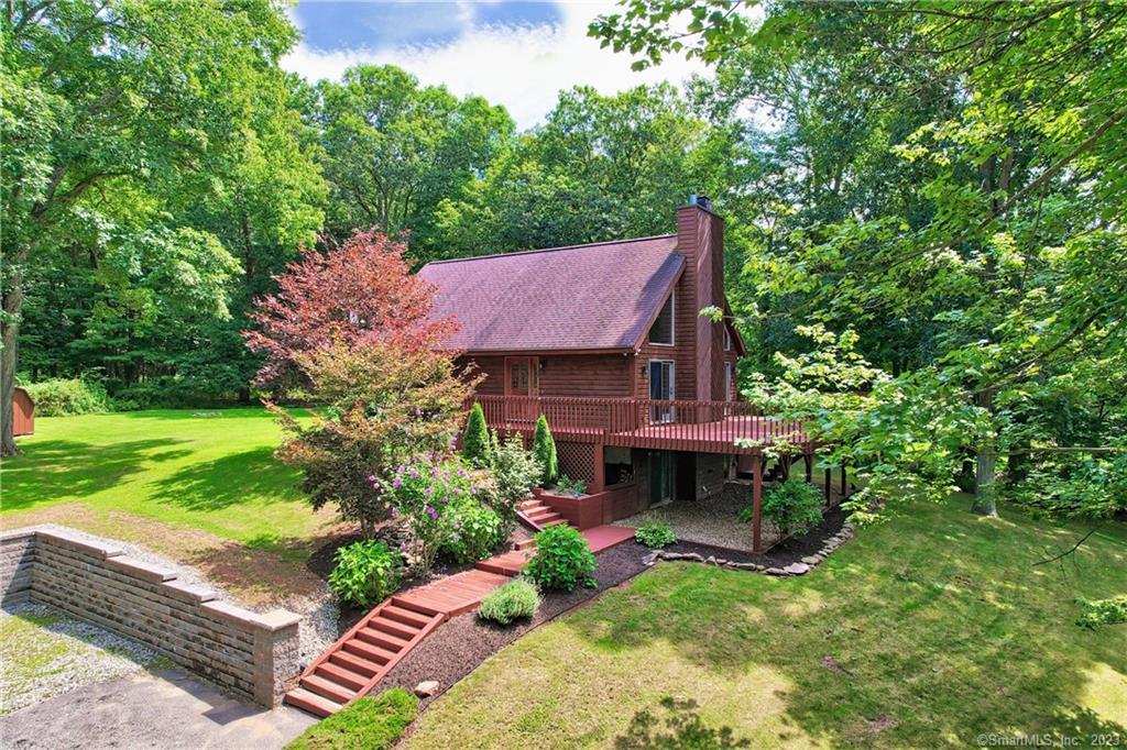 63 Woodbridge Road Coventry, CT 06238 - Photo 1 of 1 a view of a house with a yard and sitting area