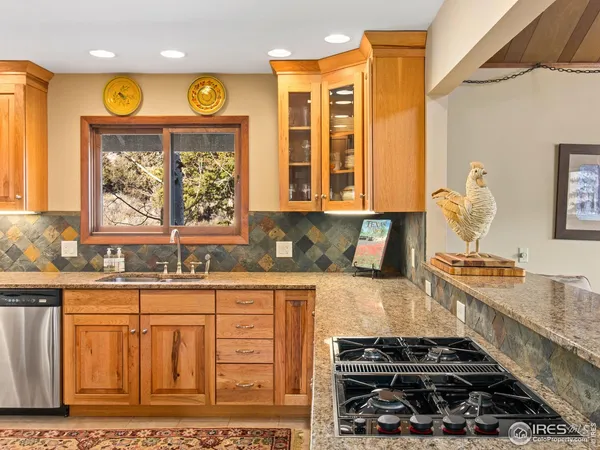 a kitchen with stainless steel appliances granite countertop a stove and a sink