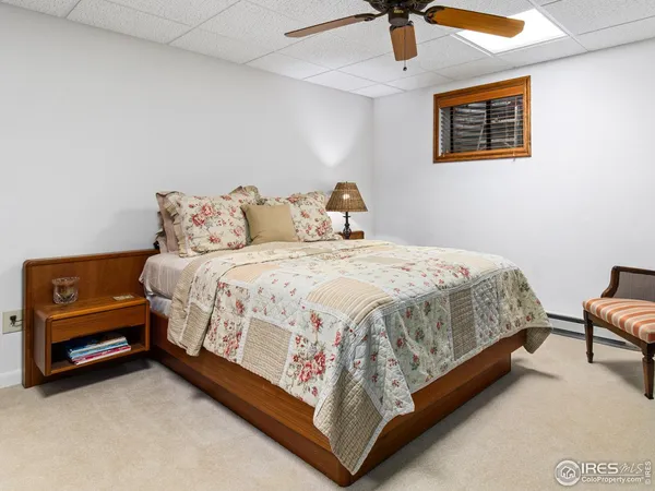 a bed sitting in a bedroom next to a lamp