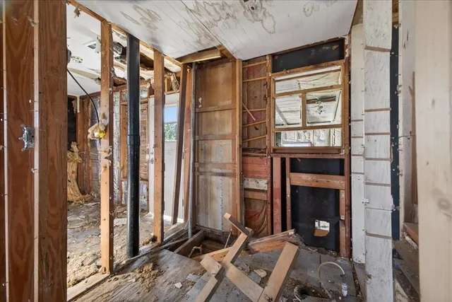 a living room with furniture a fireplace and next to a window