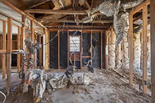 a kitchen with stainless steel appliances granite countertop a table chairs refrigerator and cabinets