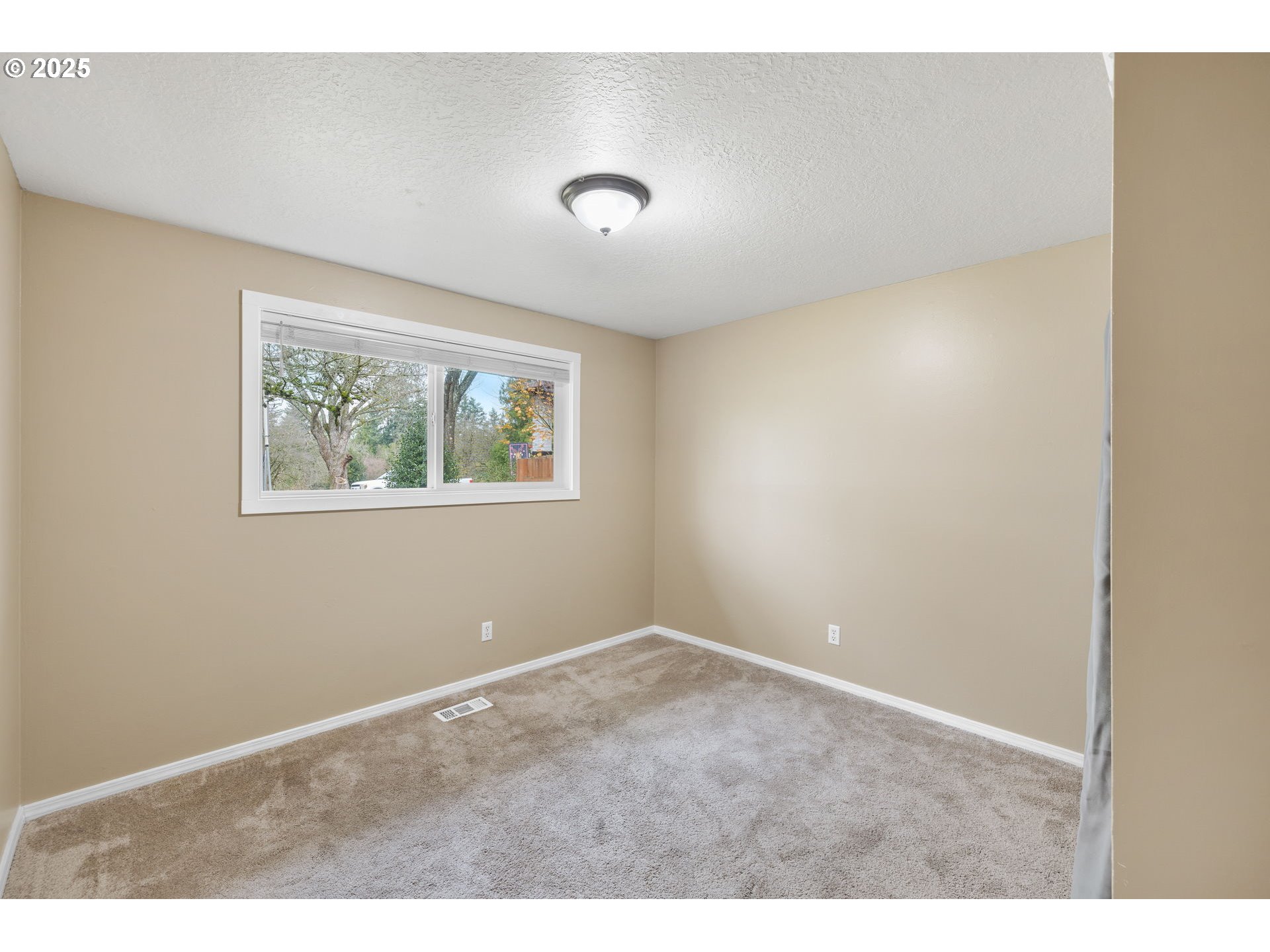 7402 Southwest Locust Street Portland, OR 97223 - Photo 16 of 25 a view of an empty room with a window