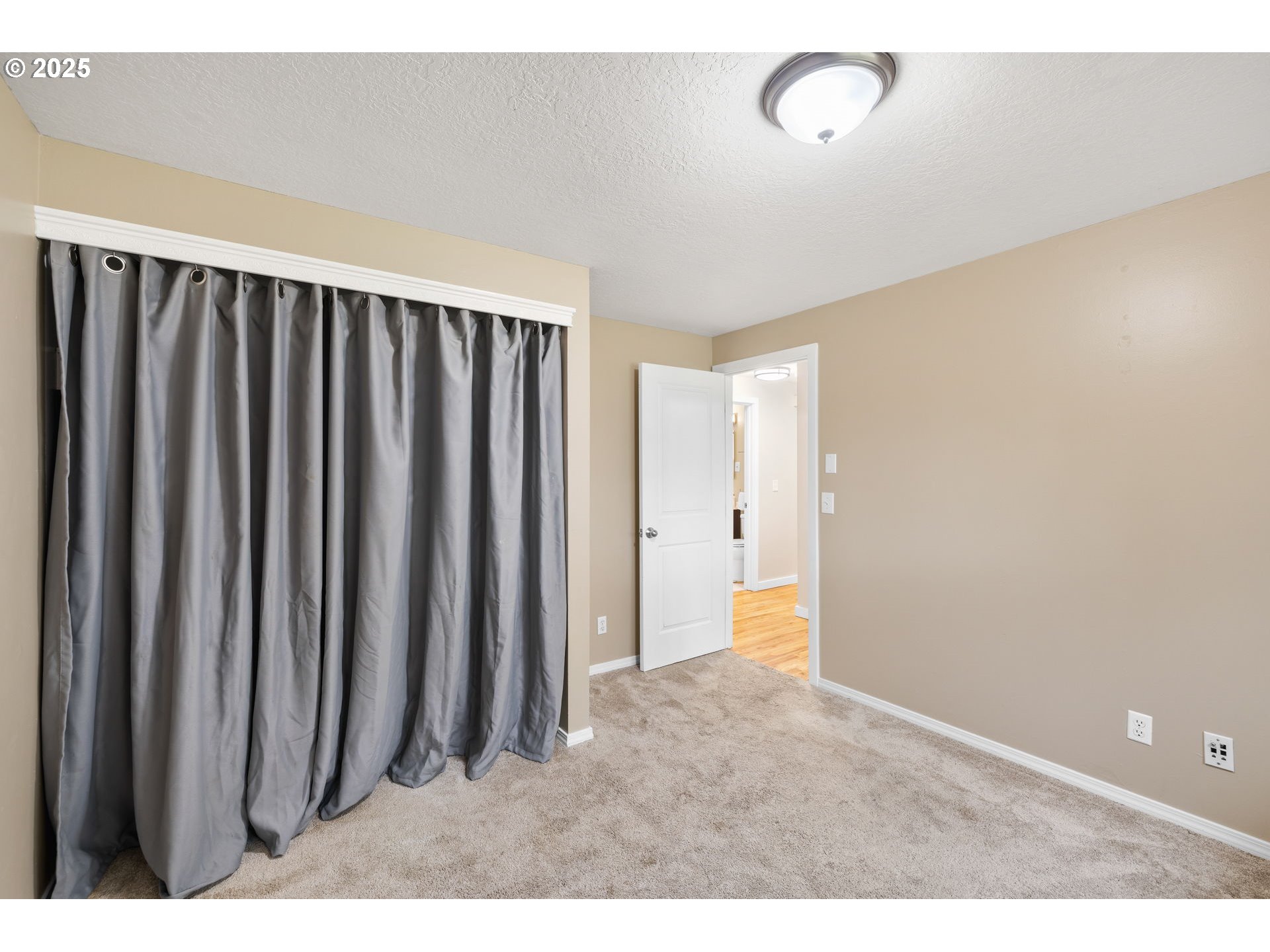 7402 Southwest Locust Street Portland, OR 97223 - Photo 17 of 25 a view of a room with wooden floor