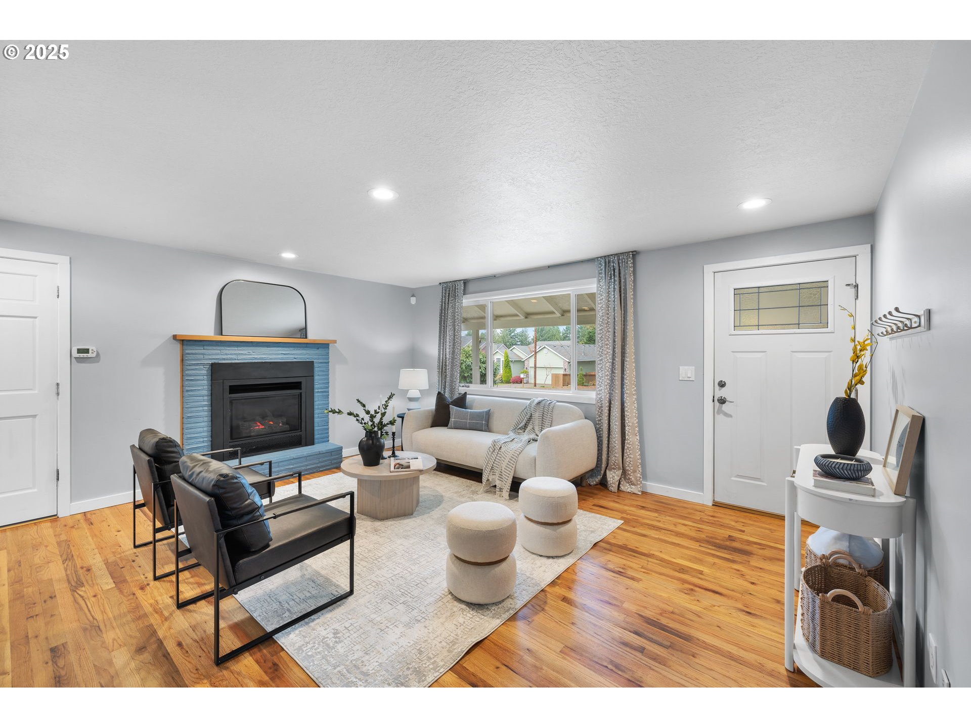 7402 Southwest Locust Street Portland, OR 97223 - Photo 4 of 25 a living room with furniture and a fireplace