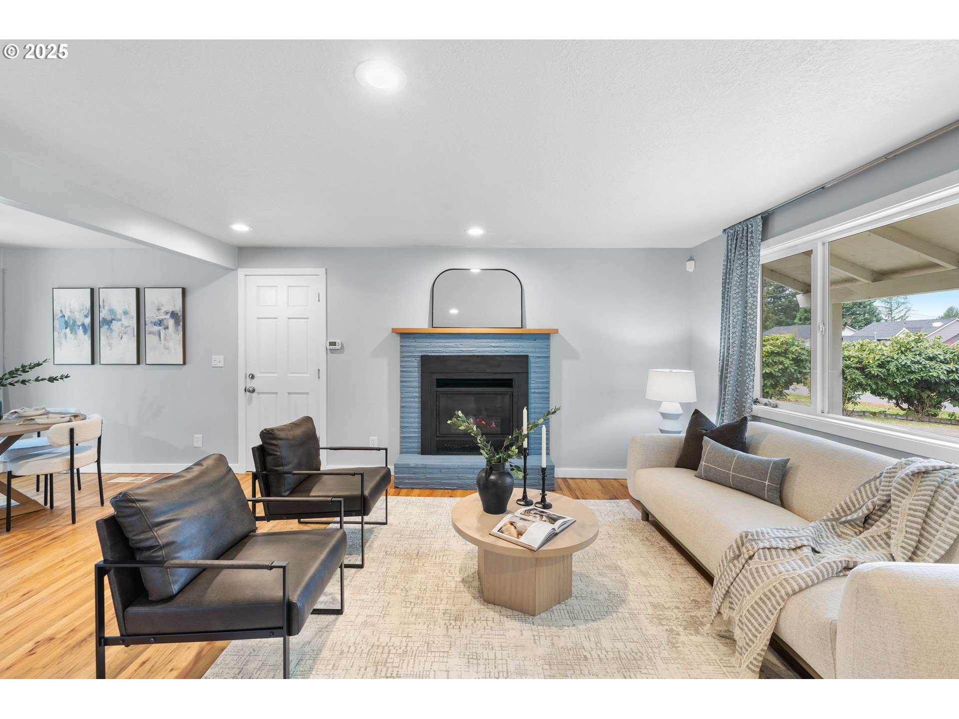 7402 Southwest Locust Street Portland, OR 97223 - Photo 5 of 25 a living room with furniture and a fireplace