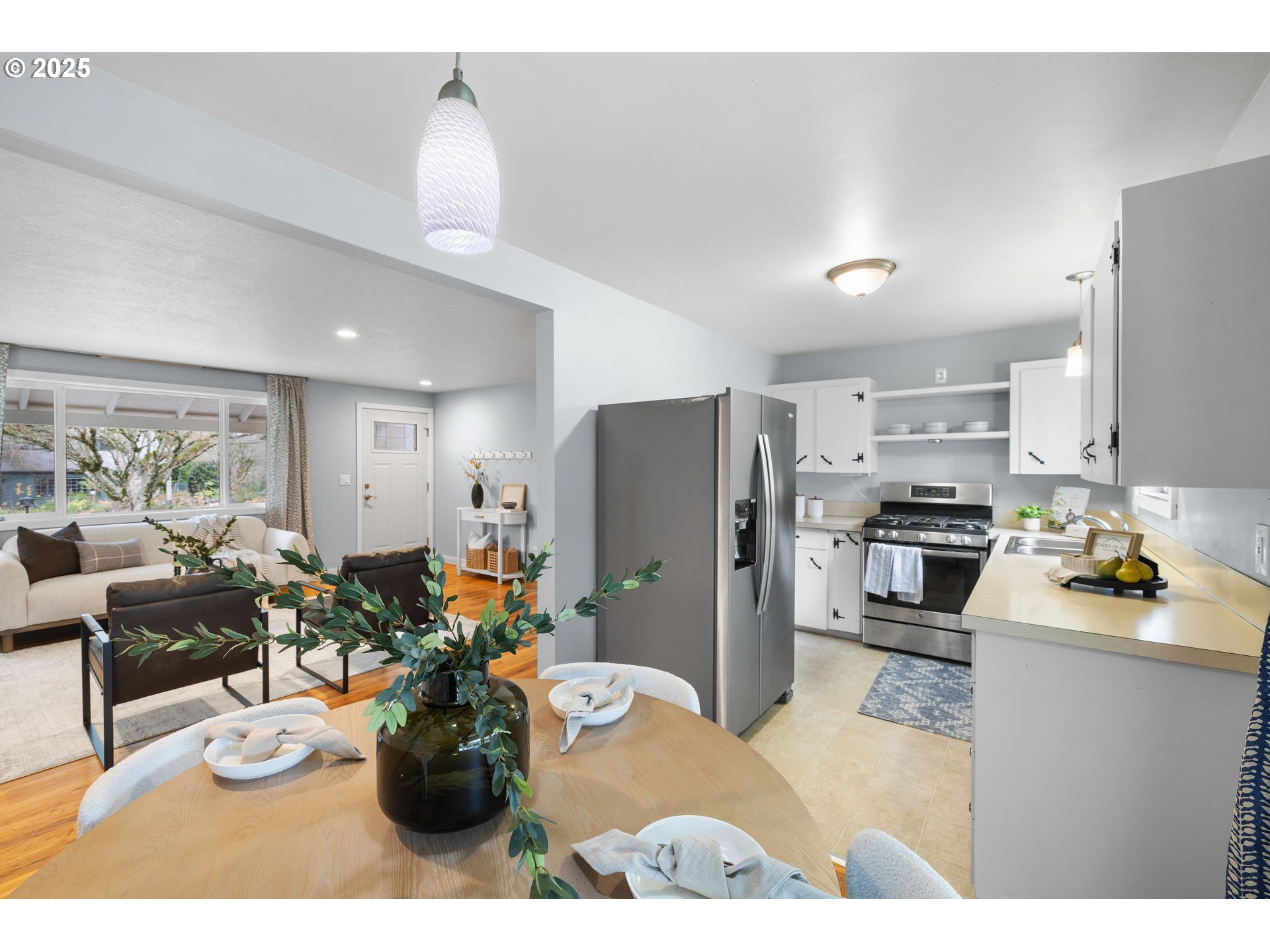 7402 Southwest Locust Street Portland, OR 97223 - Photo 9 of 25 a kitchen with a refrigerator and a view of living room