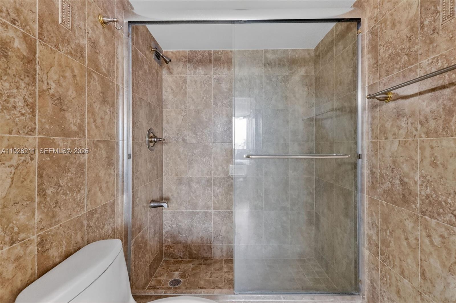 7135 Collins Avenue, Unit 1015 Miami Beach, FL 33141 - Photo 23 of 41 a bathroom with a shower and a sink