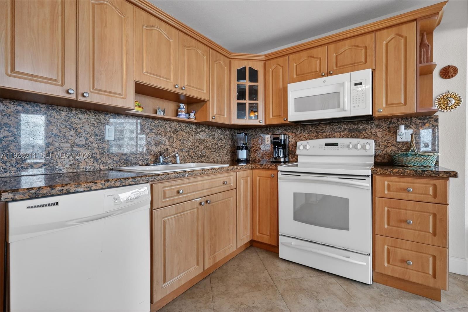 7135 Collins Avenue, Unit 1015 Miami Beach, FL 33141 - Photo 8 of 41 a kitchen with stainless steel appliances granite countertop cabinets and a microwave oven