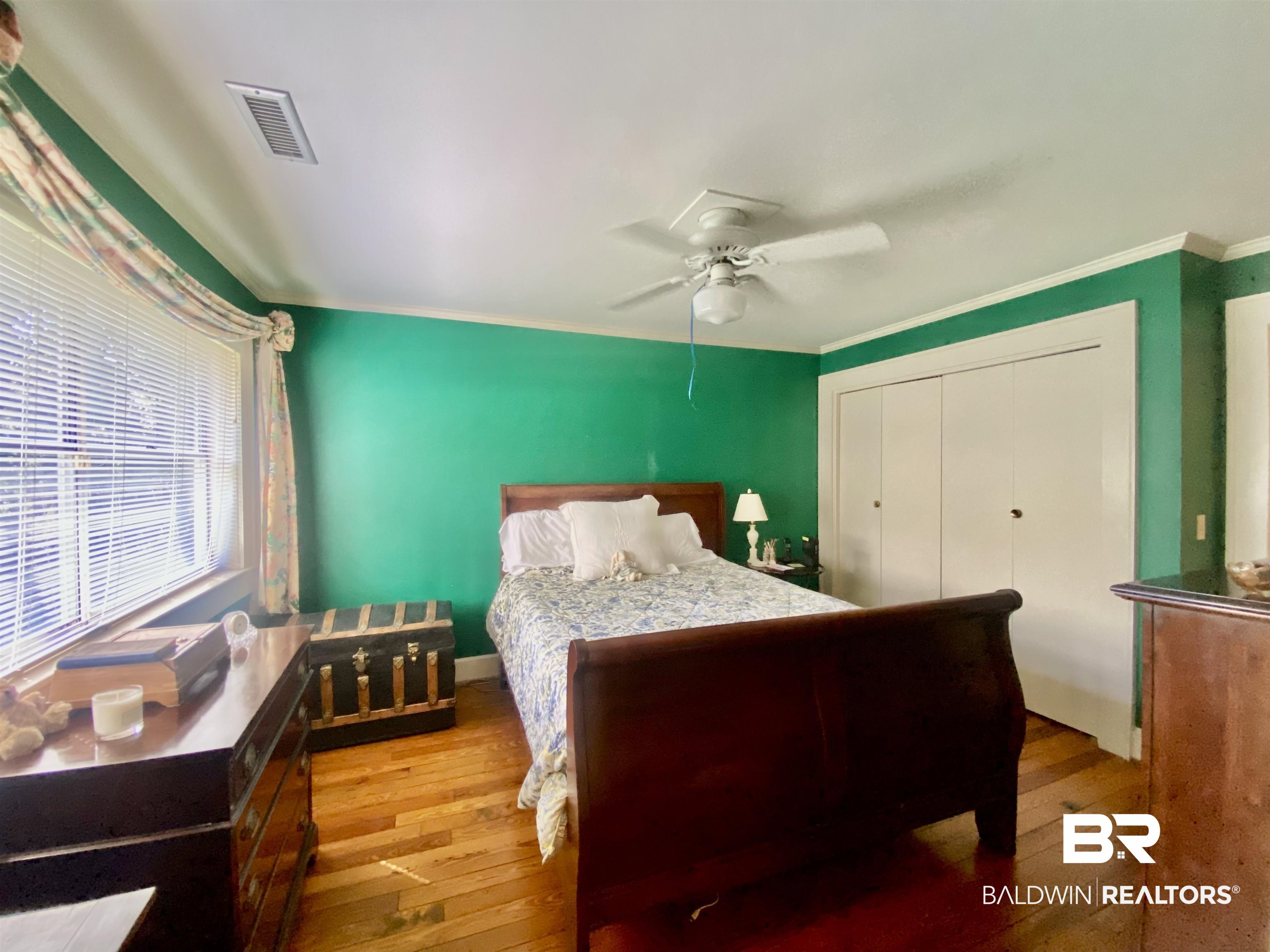272 Longleaf Circle Monroeville, AL 36460 - Photo 21 of 38 Bedroom featuring crown molding, ceiling fan, a closet, and hardwood / wood-style flooring