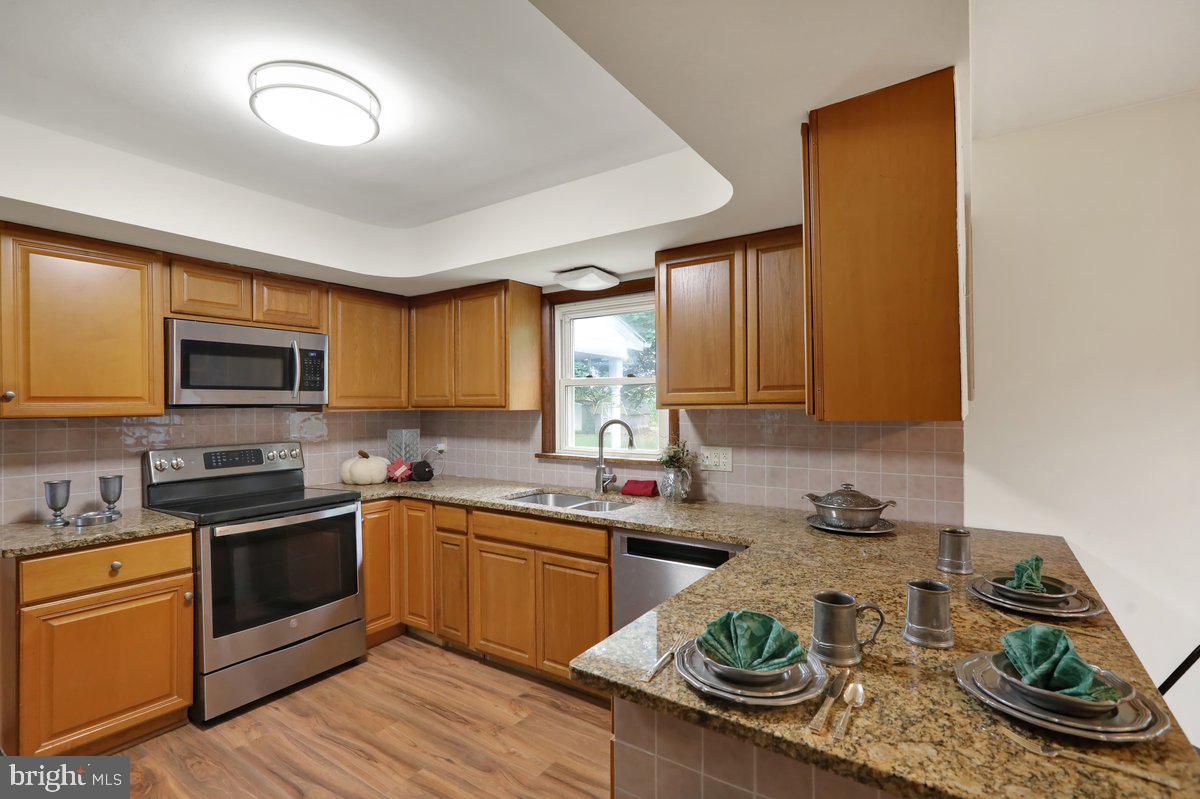 1734 Becker Road Manheim, PA 17545 - Photo 11 of 30 a kitchen with stainless steel appliances granite countertop a sink dishwasher stove and cabinets
