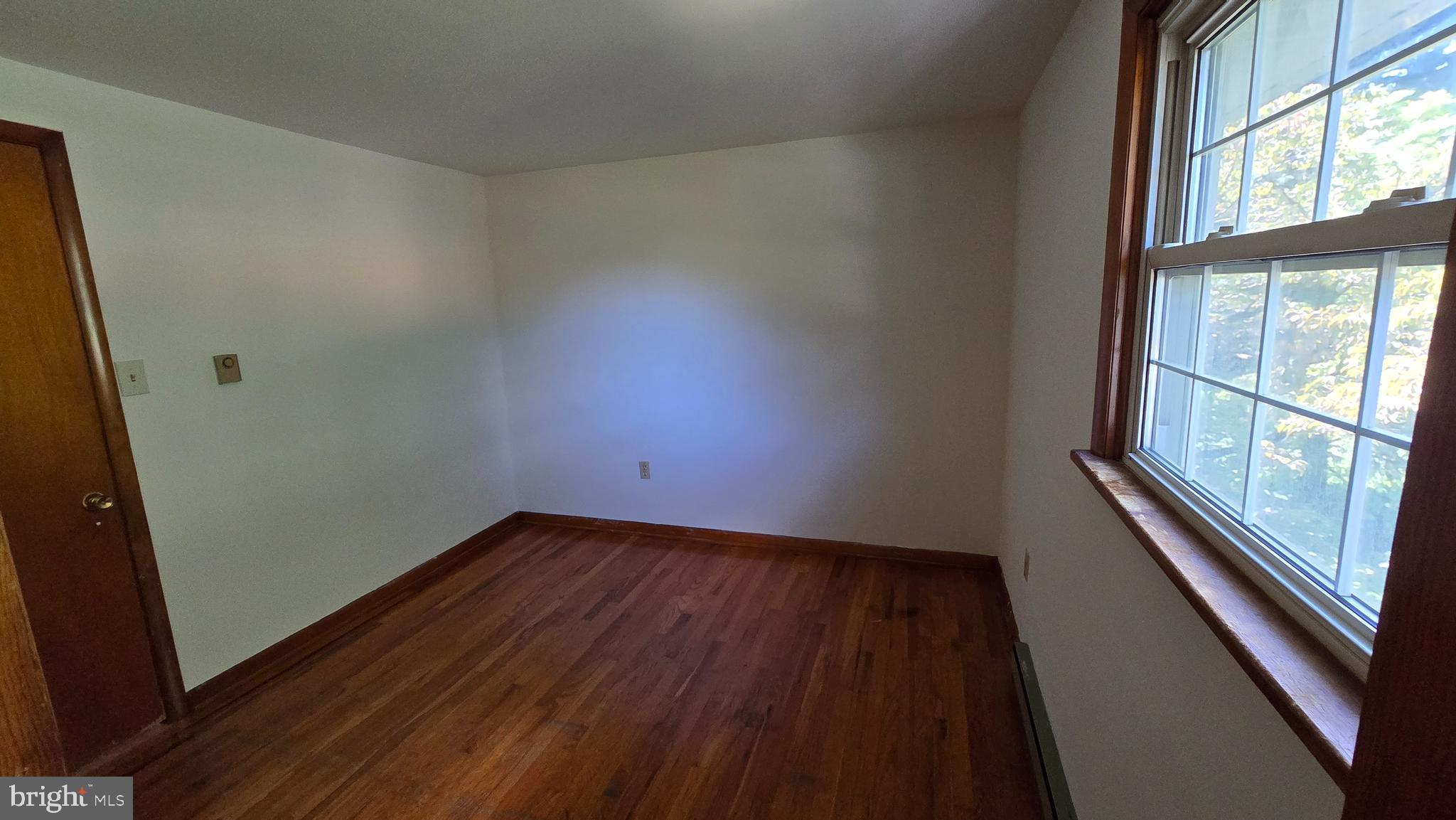 1734 Becker Road Manheim, PA 17545 - Photo 22 of 30 an empty room with wooden floor and windows