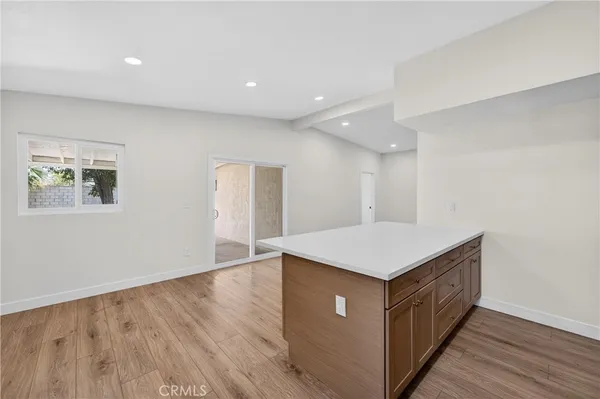 a kitchen with a sink a wooden floor and a window