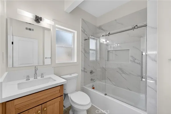 a bathroom with a sink shower bathtub and a toilet