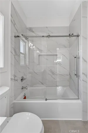 a bathroom with a toilet and a bath tub