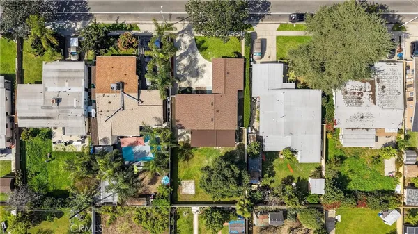 an aerial view of residential houses with outdoor space and swimming pool
