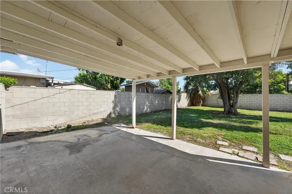 a view of a house with backyard and a patio
