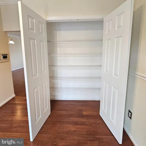 a view of a room with wooden floor and staircase